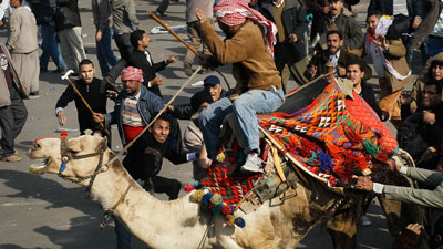 Men riding horses and camels ran at the crowd but were pulled off the animals